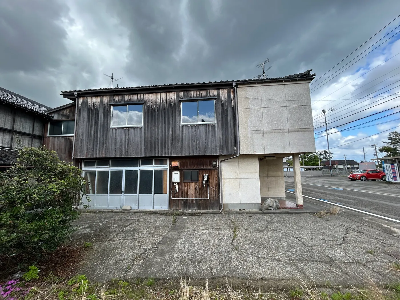 The building before construction. A two-story wooden-clad house